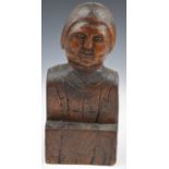 19th or early 20thC carved wood naive or folk art figure of a man with sideburns, wearing a bow