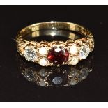 A 9ct gold ring set with a garnet, pearls and two diamonds, each approximately 0.25ct, 3.4g, size S