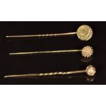 Two 9ct gold Victorian stick pins (2g) and a stick pin set with a half dollar coin (1.1g)