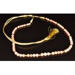 A beaded coral necklace and ridged gold beads