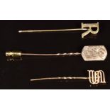 Three 9ct gold stick pins, one a letter 'R', one a letter 'S' and the other engraved, 3.4g