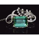 An 18k white gold brooch set with an emerald cut tourmaline of approximately 16.9ct and diamonds