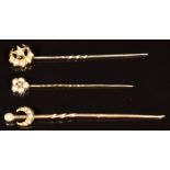 Three Victorian stick pins, one in the form of a crescent and star set with a diamond and seed