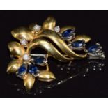 An 18ct gold brooch in a stylised foliate design set with marquise cut sapphires and diamonds, 9.0g,