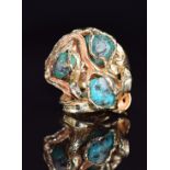 A 1970s 9ct gold ring set with three turquoise boulders in an abstract cage mount, Birmingham