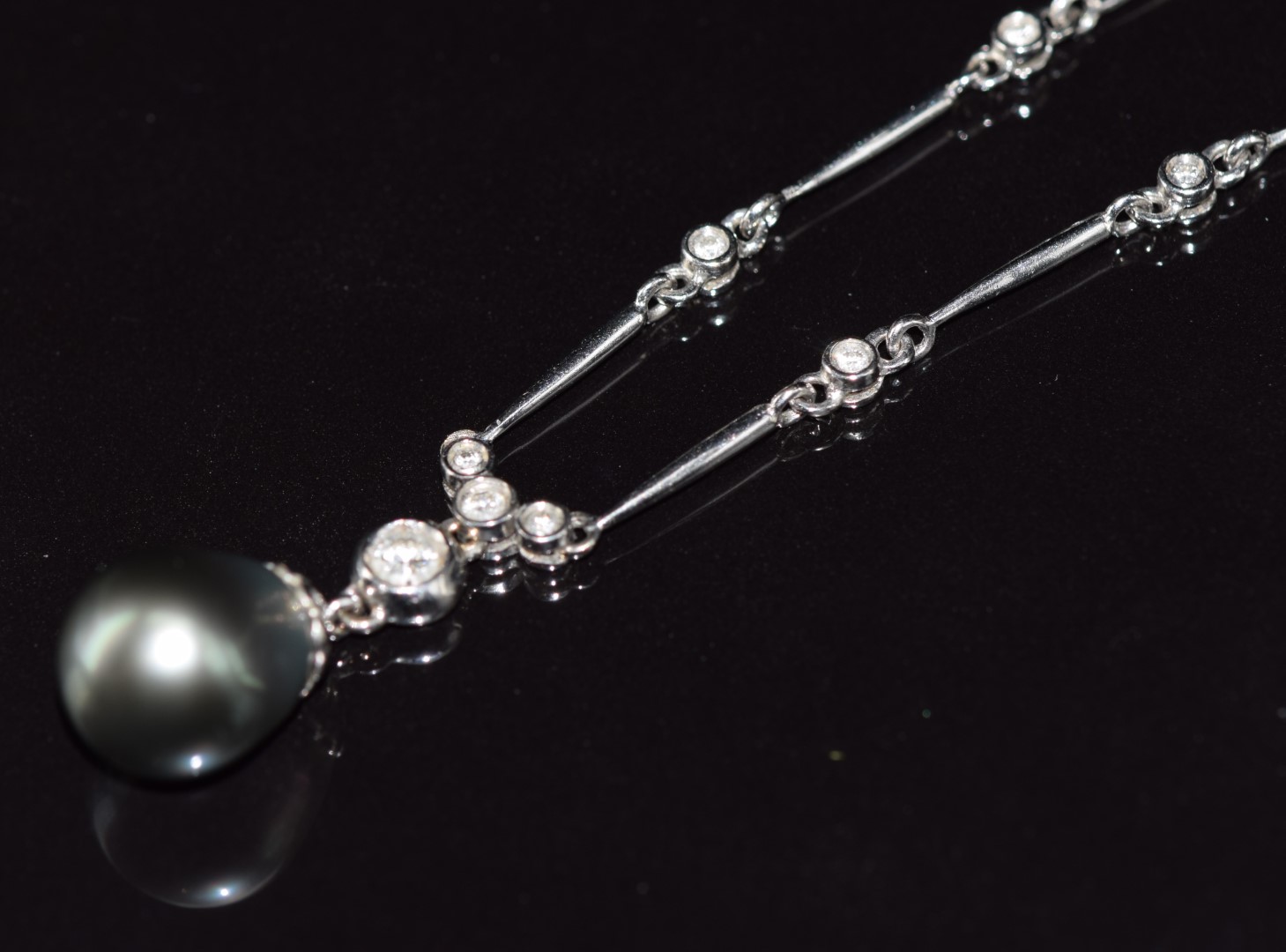 An 18ct white gold necklace / necklet set with a Tahitian pearl (10.6 x 12.2mm) and 24 diamonds, the