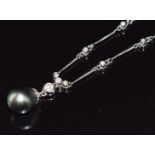 An 18ct white gold necklace / necklet set with a Tahitian pearl (10.6 x 12.2mm) and 24 diamonds, the