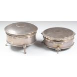 Two hallmarked silver dressing table trinket boxes, both raised on three feet, one Walker & Hall,