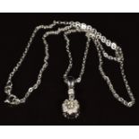A 14k white gold pendant set with a cluster of diamonds, on 14k white gold chain, 3g - See lot