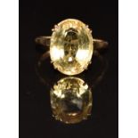 A 9ct gold ring set with an oval cut citrine, 4.4g, size R