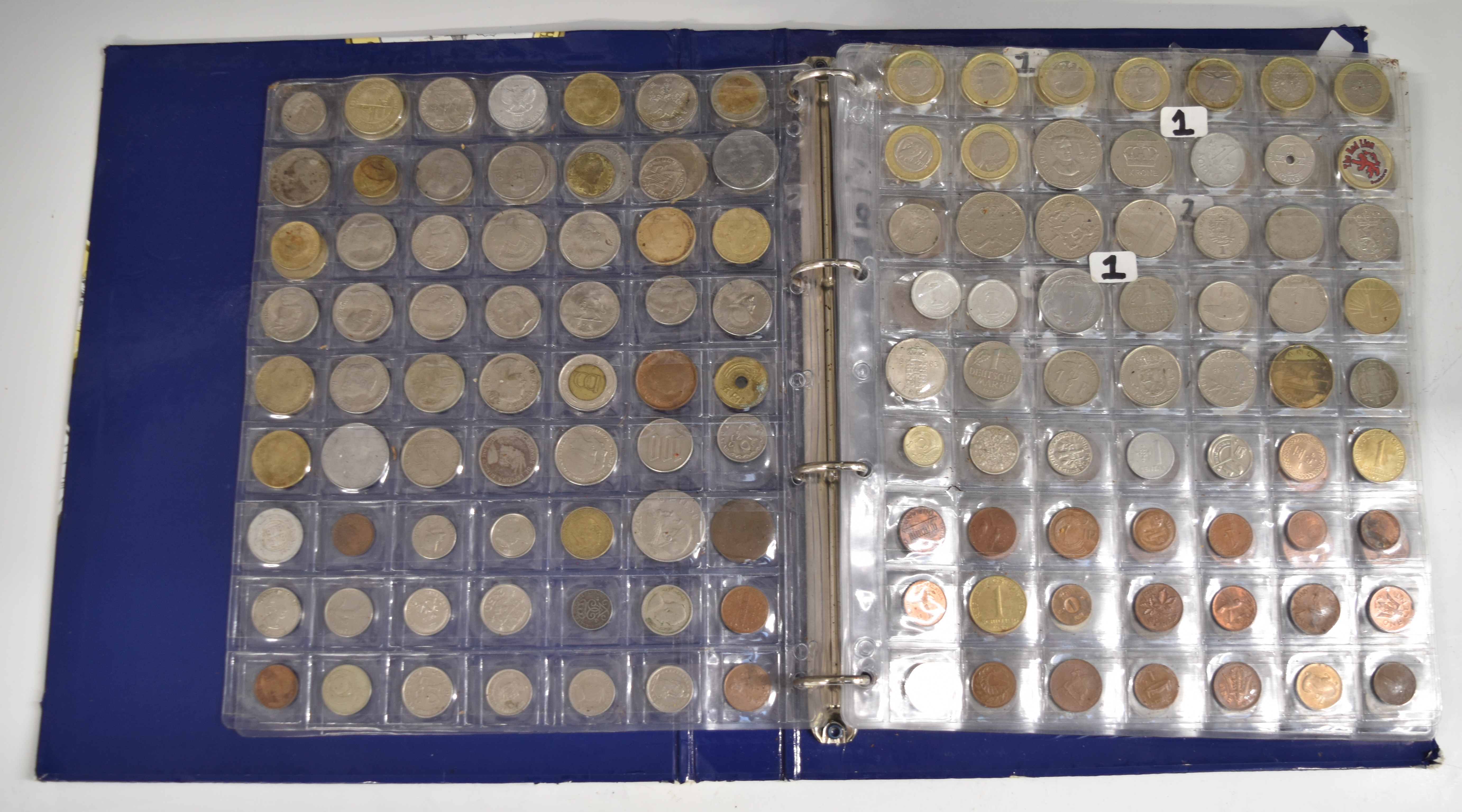 A collection of world coins contained in a Change Checker album