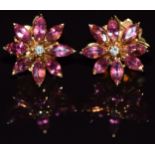 A pair of 18ct gold Asprey earrings, each set with a diamonds surrounded by marquise cut pink