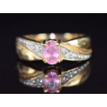 A 14k gold ring set with a pink sapphire and diamonds, 2.9g, size L