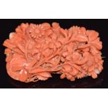 A 14k gold brooch set with carved coral in the form of flowers, 28.4g