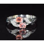 An 18ct white gold ring set with Ceylon padparadscha sapphire and diamonds, 3.4g, size N