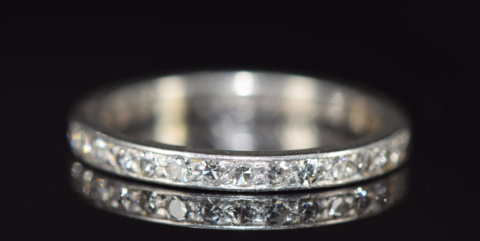 A c1940 platinum half eternity ring set with diamonds, 3.4g, size L