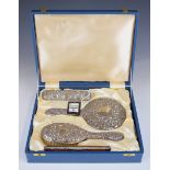 Broadway hallmarked silver dressing table set in original box, comprising hand mirror two brushes