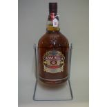 A 4.5 litre bottle of Chivas Regal 12 year old blended whisky, in metal cradle.