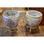Two similar modern Chinese porcelain fish bowls, largest 26.5cm high, each on wood stand.