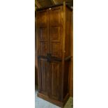 A modern oak hall cupboard, with leather studded decoration, 216cm high x 77cm wide x 43cm deep.