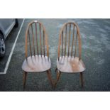 A pair of Ercol dining chairs.