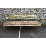 An antique wrought iron bench, having wooden slats, 184cm wide.
