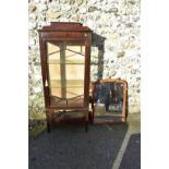 An Edwardian glazed display cabinet; together with an antique walnut mirror.
