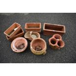 A quantity of terracotta planters and pots.