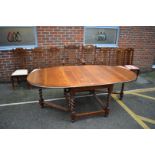 An antique oak gateleg table, 210cm extended; together with a set of eight Arts and Crafts style