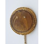 (NB) A late Victorian yellow metal stick pin, the terminal set with a carved citrine cameo of a