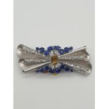 (NB) A satin textured brooch/double clip set diamonds and sapphires, by Alabaster & Wilson,