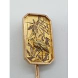 (NB) A Victorian yellow metal chinoiserie stick pin, unmarked, decorated with stork and bamboo,