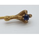 (NB) A Victorian yellow metal stickpin, with terminal of a birds claws grasping a sapphire, 7cm.