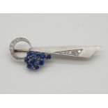 (NB) A frosted metal brooch set sapphires and diamonds, stamped 'Plat', by Alabaster & Wilson,
