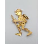 (NB) A circa 1920s yellow metal articulated Boy Scout charm, having movable arms and legs, stamped