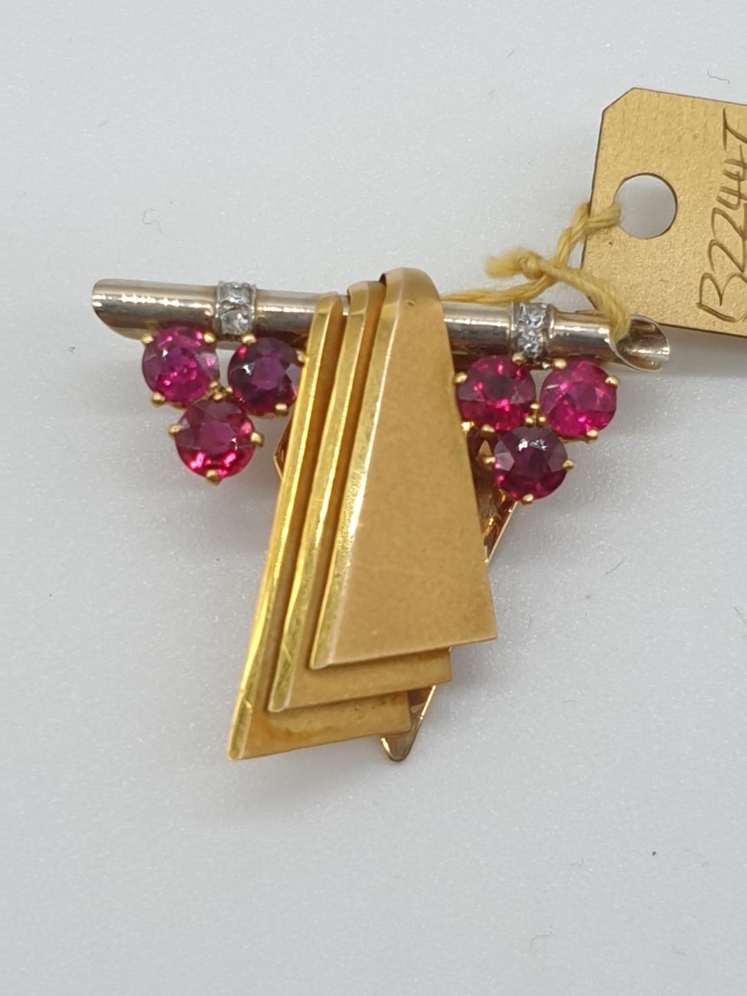 (NB) A yellow metal ruby and diamond clip, stamped 14ct, by Alabaster & Wilson, 28 x 25mm, gross