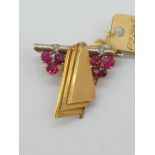 (NB) A yellow metal ruby and diamond clip, stamped 14ct, by Alabaster & Wilson, 28 x 25mm, gross