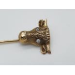 (NB) A late Victorian yellow metal stickpin, the terminal decorated Taurus with diamond set eyes,