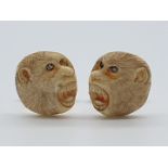 (NB) A pair of Chinese or Japanese carved ivory monkey face cufflinks, with yellow metal turn buckle