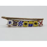 (NB) A 9ct gold and coloured enamel flag brooch, decorated semaphore flags 'Vikings' on a gold