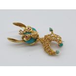 (NB) A novelty textured yellow metal novelty Donkey brooch, with turquoise head and ruby eyes,