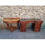 An antique mahogany kneehole desk, with leather top, 128cm wide x 54cm deep; together with a