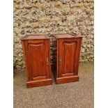 A pair of late Victorian walnut bedside cupboards, 38cm wide, (lacking tops). (2)