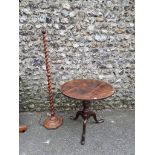 An antique oak circular tripod table; together with a similar barleytwist standard lamp.