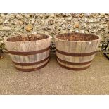 A pair of coopered wood and metal bound planters.