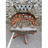 A leather buttoned desk chair.