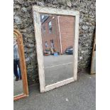 A large green painted wall mirror, with bevelled plate, 176cm x 104cm.