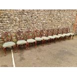 A set of eleven antique carved walnut dining chairs.