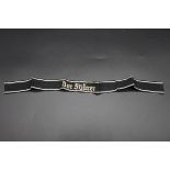 A German 'Der Fuhrer' cuff title, with silver thread embroidered detail, 44.5cm long.