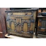 A reproduction carved oak side cabinet, 91cm wide.